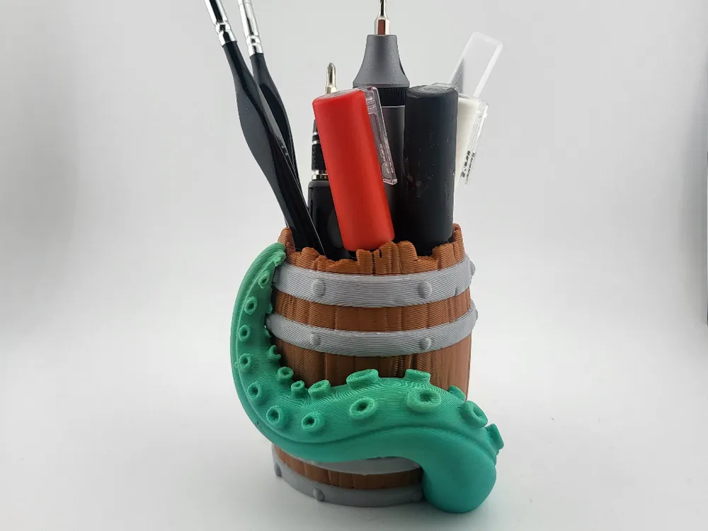 Pen holder in the shape of a barrel with tentacle